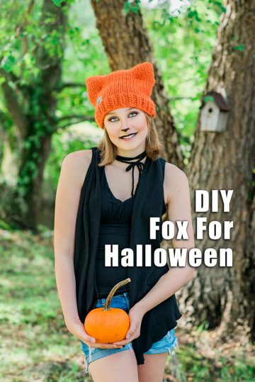 Teenager wearing hand knit orange hat and makeup for a fox Halloween costume